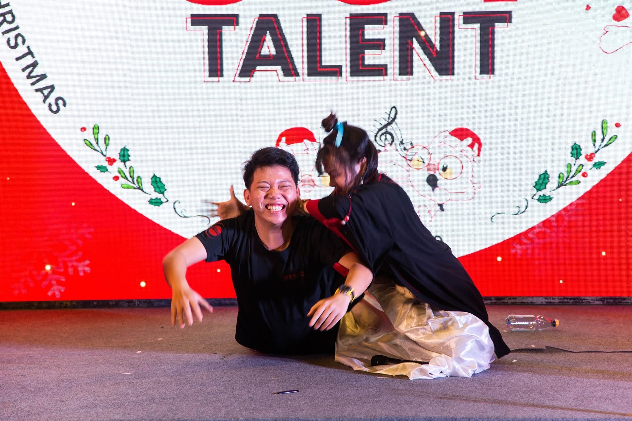 Enouvo teammates performing a playful act on stage