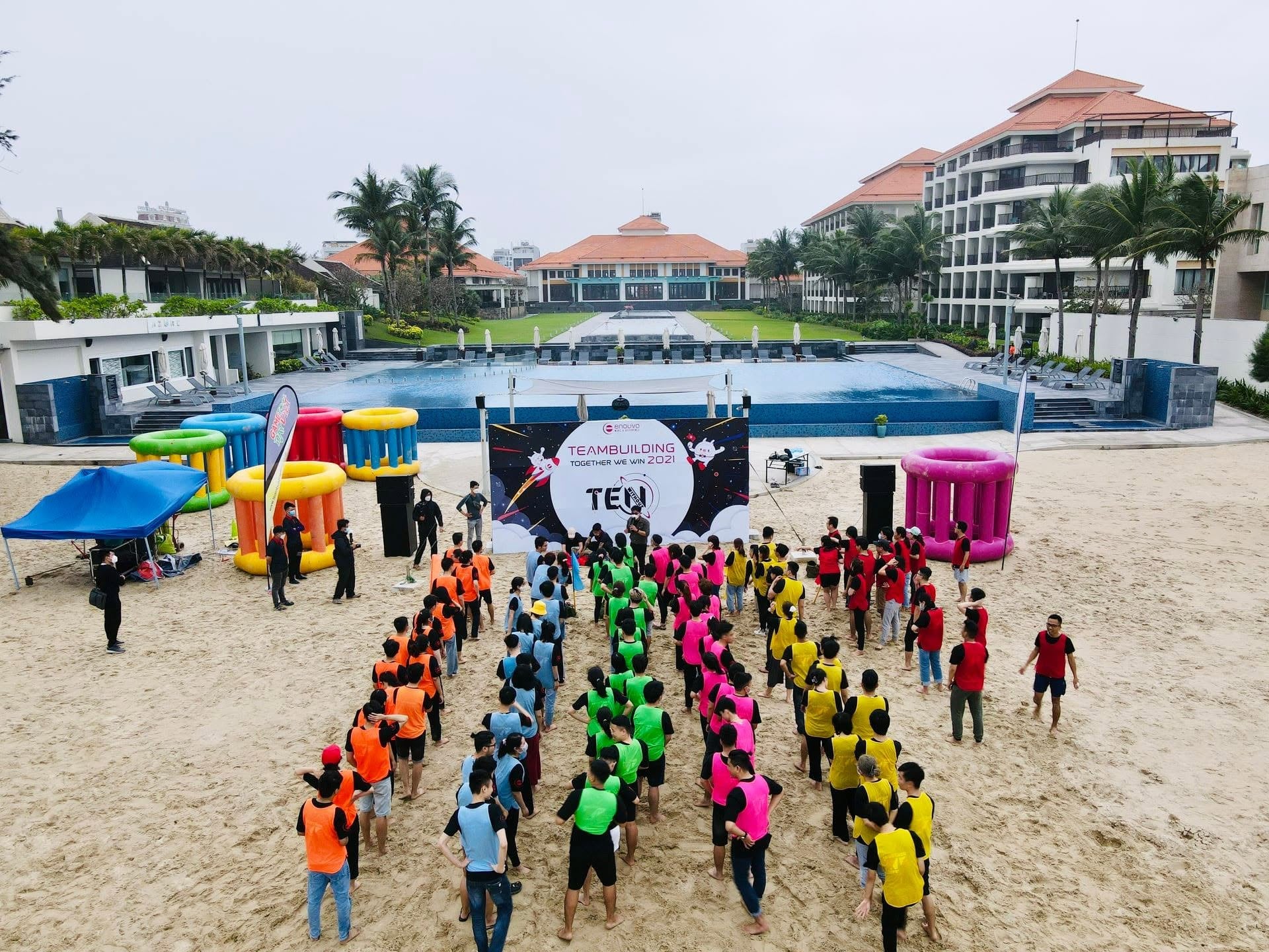 Aerial view of Enouvo teams gathering beside the pool during a company trip