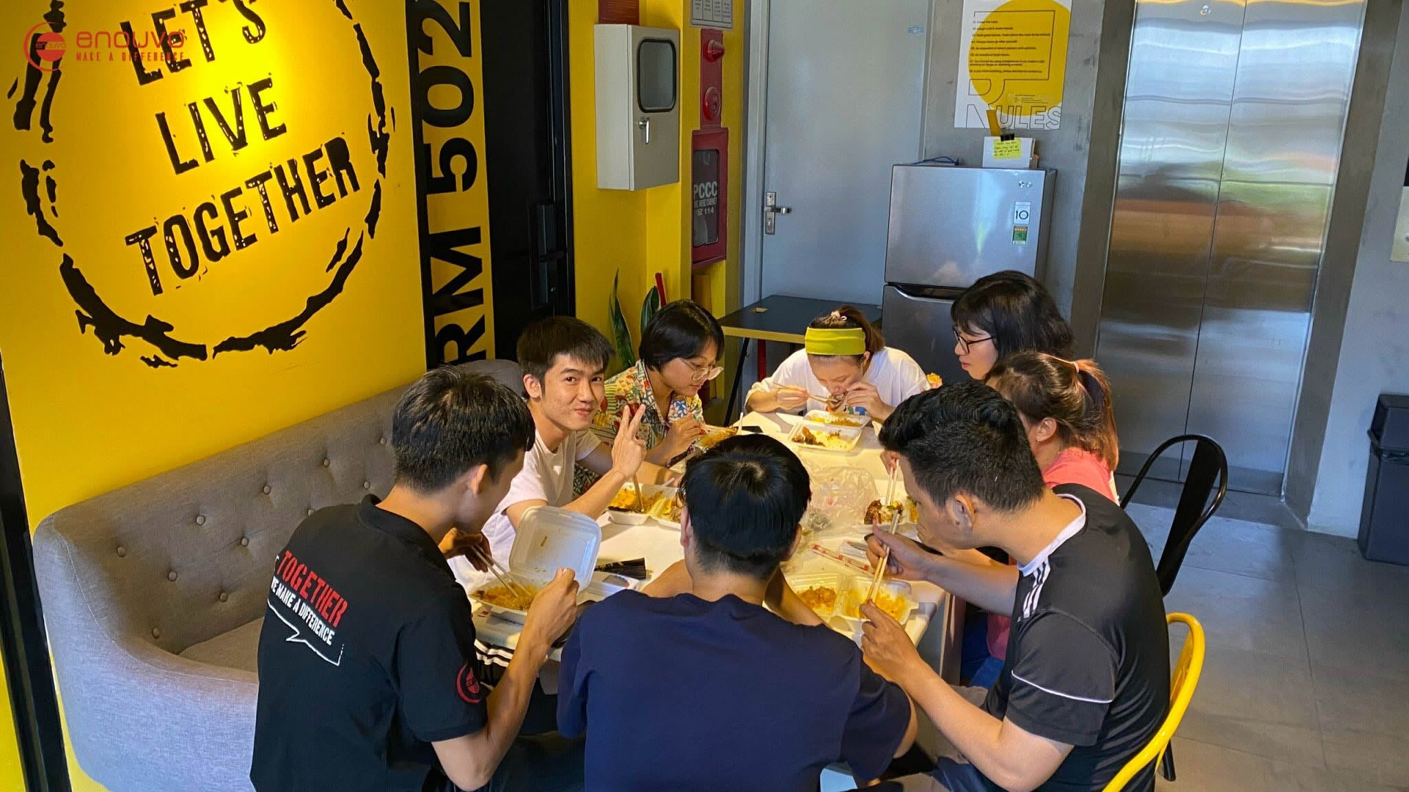 Enouvo teammates sharing lunch and conversation around a table