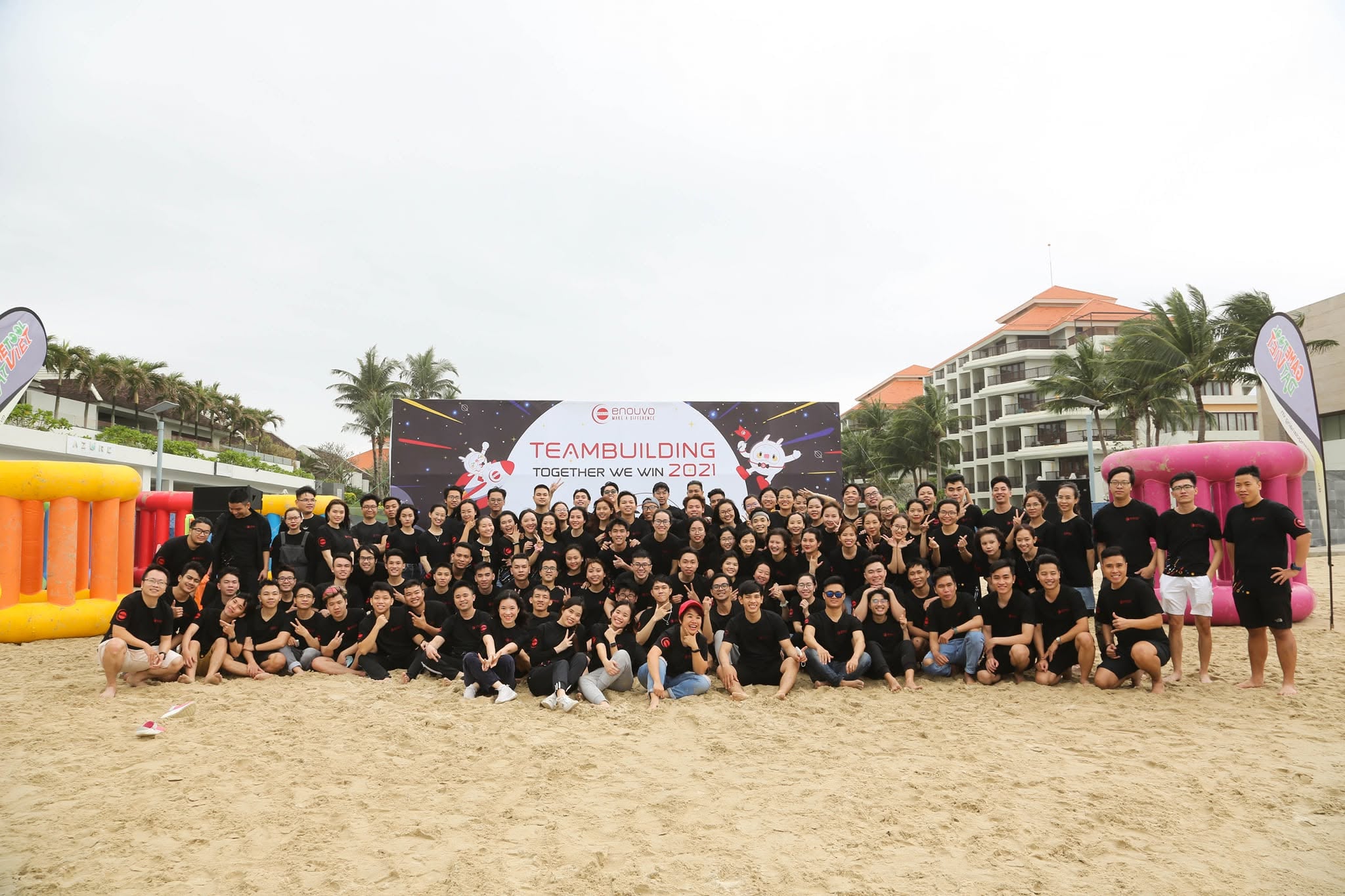 Enouvo colleagues gathering for a team photo on the beach