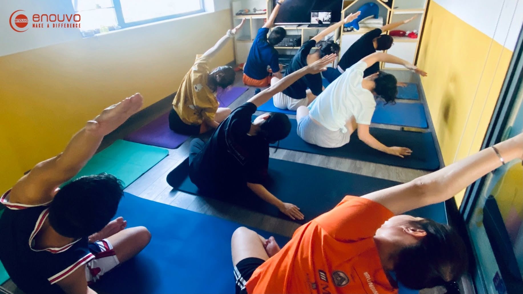 Enouvo team members taking part in a group yoga and wellness session