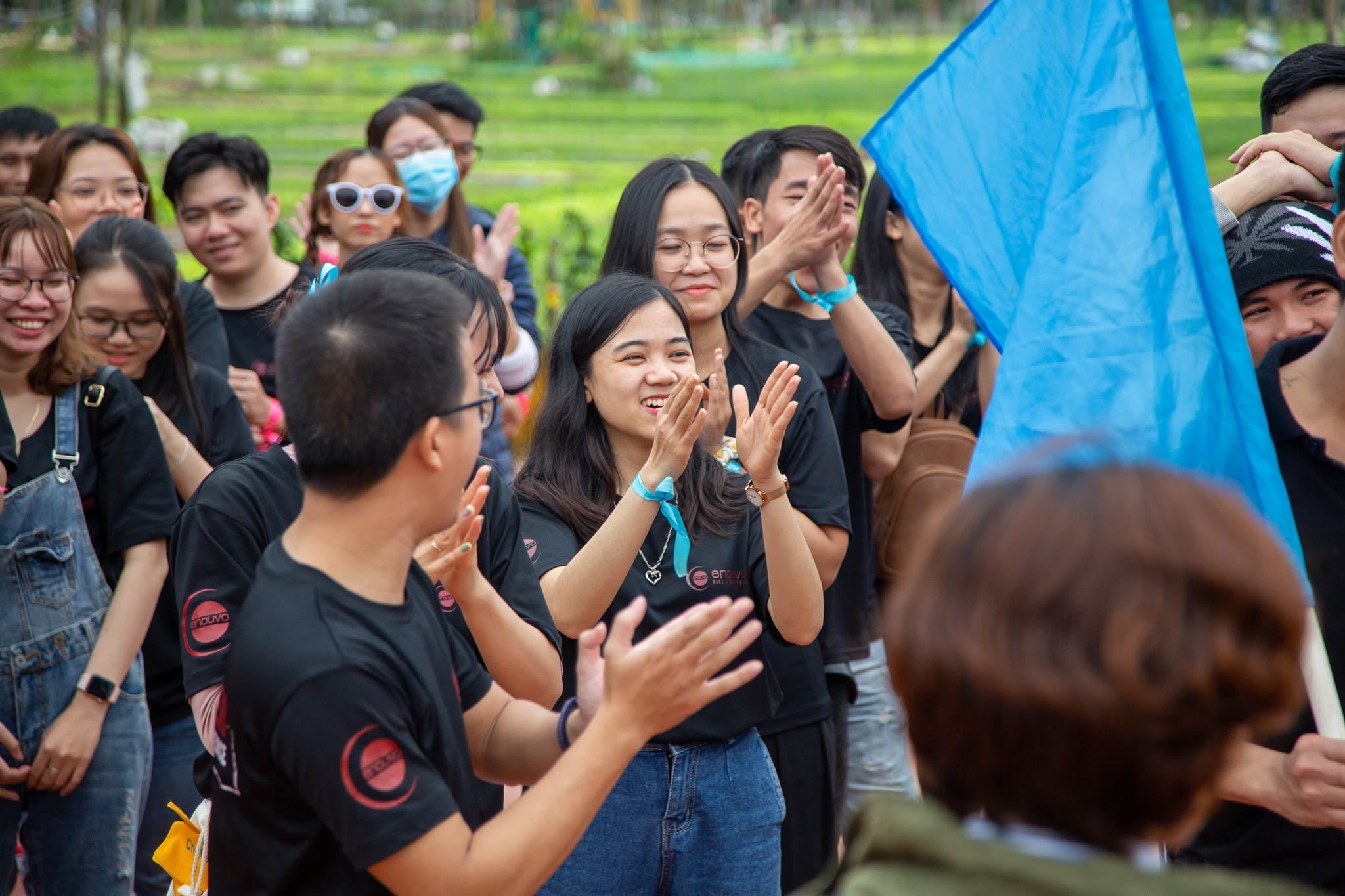 Enouvo teammates cheering during an outdoor team-building game