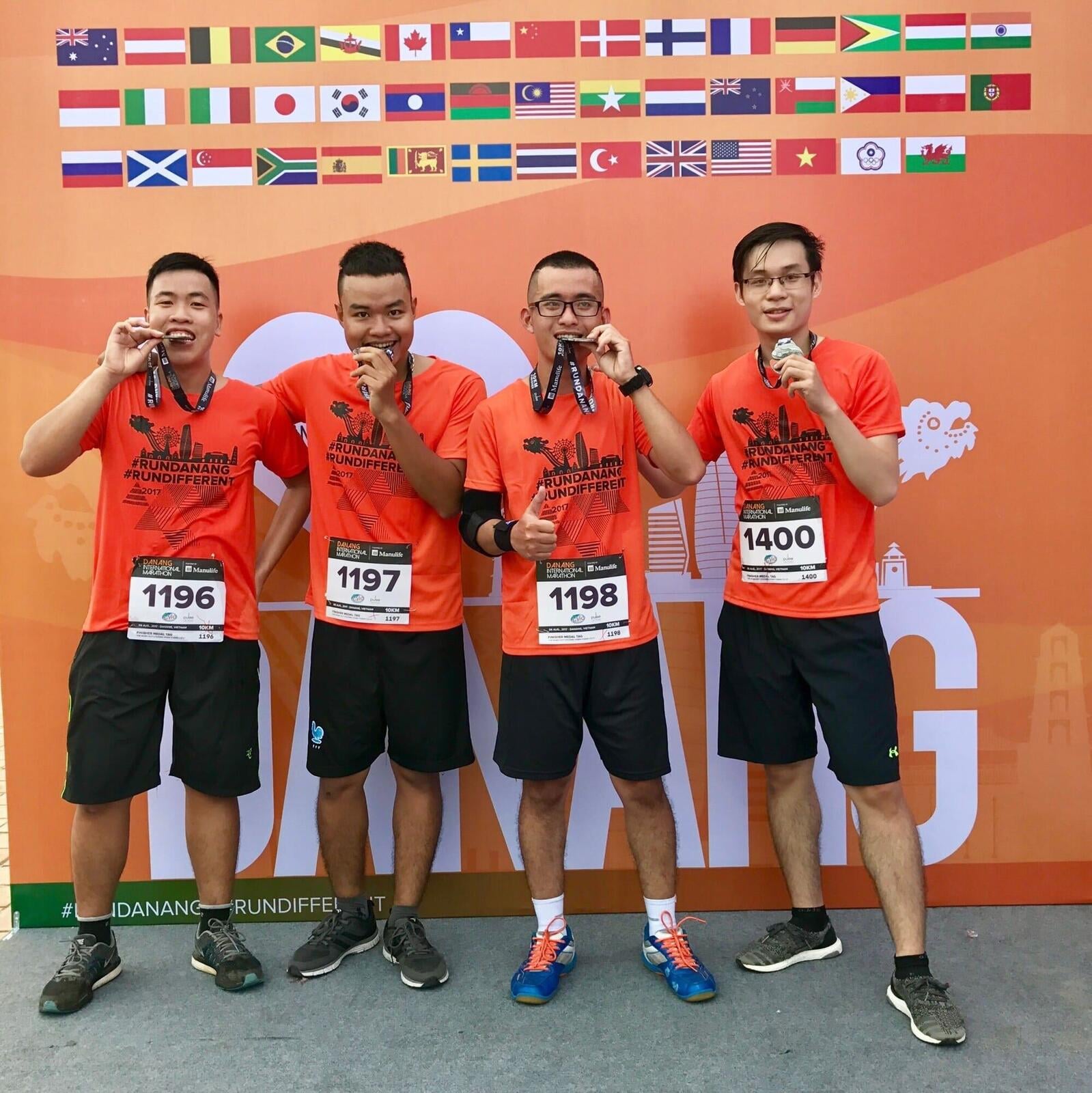 Four Enouvo team members with medals at the 2017 Da Nang International Marathon